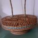 Glass holder and wicker bottle with green plastic water surface