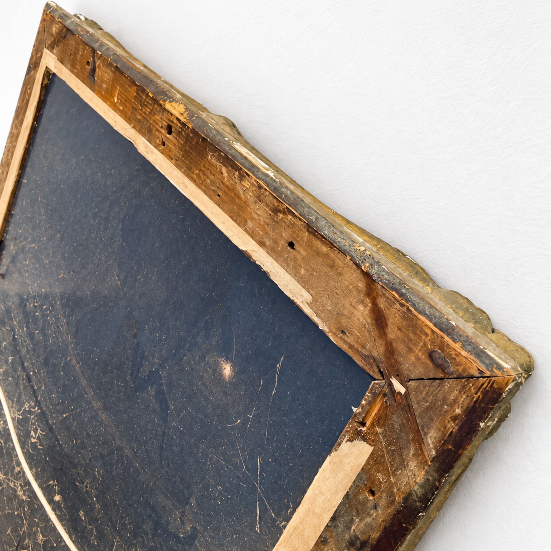 Antique mirror with a gilded frame and foliage decoration.