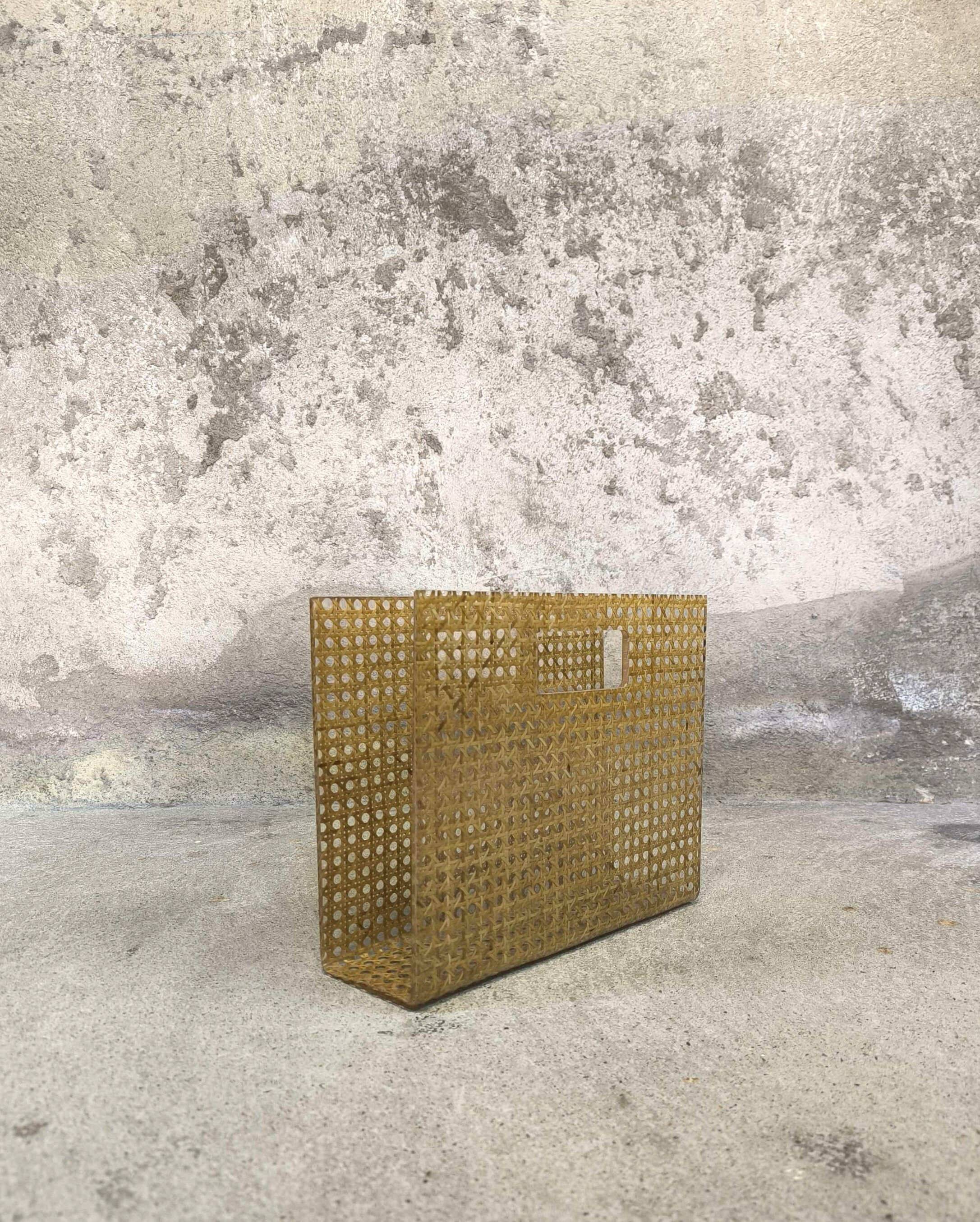 Vintage magazine rack in plexiglass and cane.