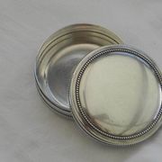 Small round silver metal box SNPA.