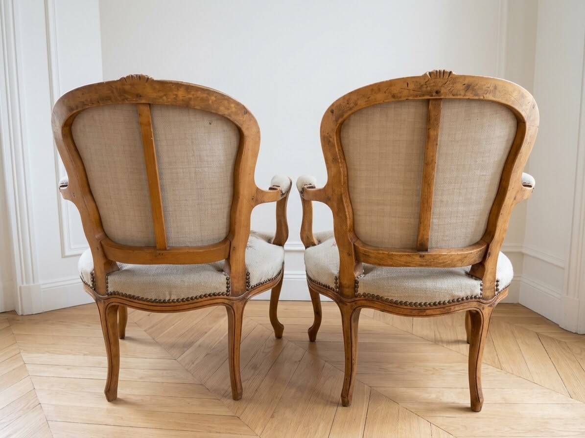 Pair of Louis XV/XVI armchairs in carved wood and floral fabric.