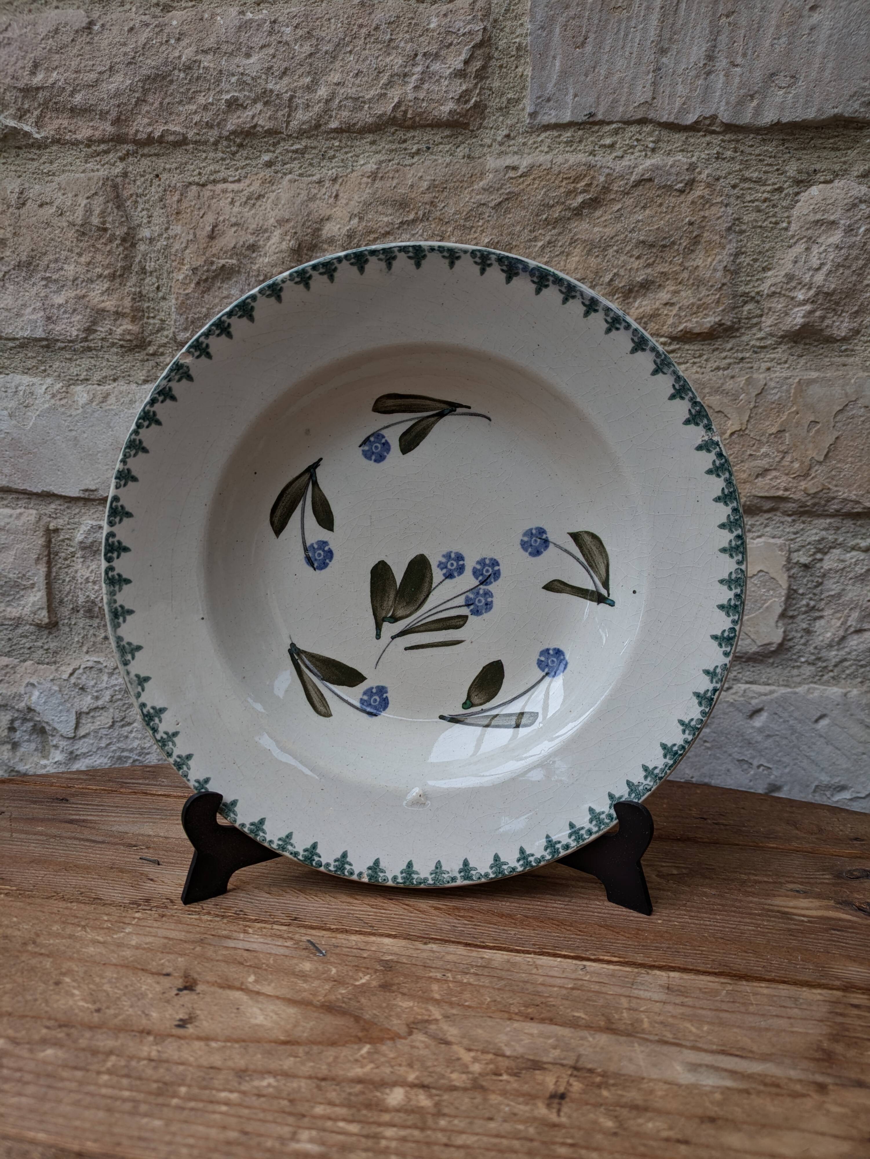 Old deep iron earth plate with blue flower pattern