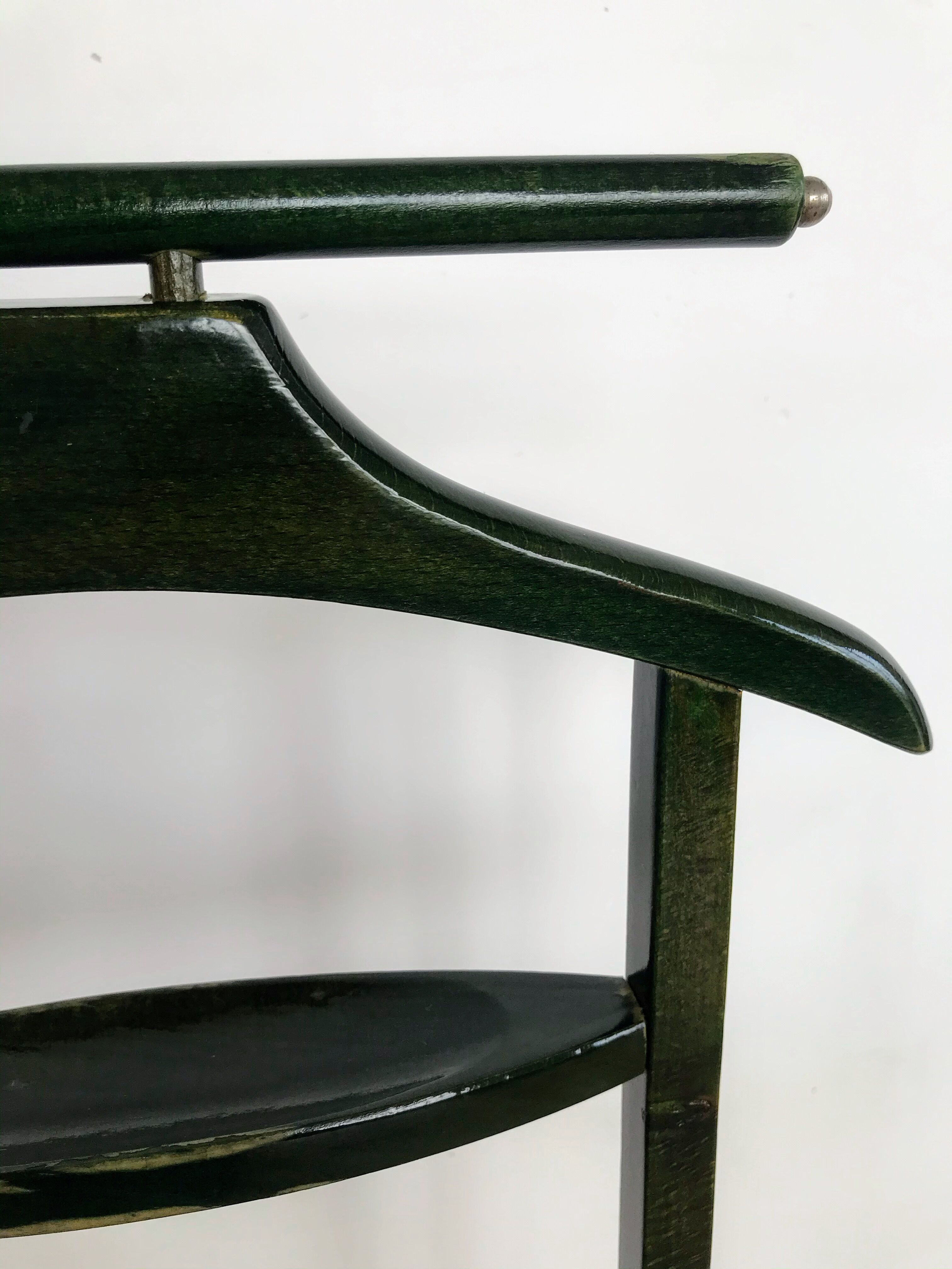 Vintage children's room valet in green varnished wood on roulette