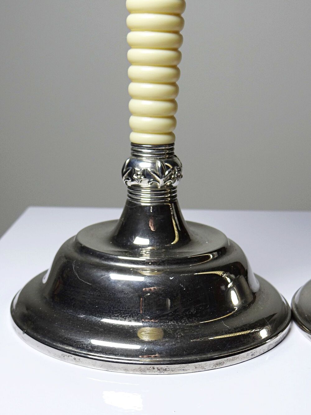 Pair of vintage candlestick holders in silver-plated metal with ivory-style plastic.