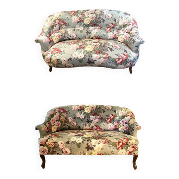 Set of two toad-shaped sofas covered in floral fabric.