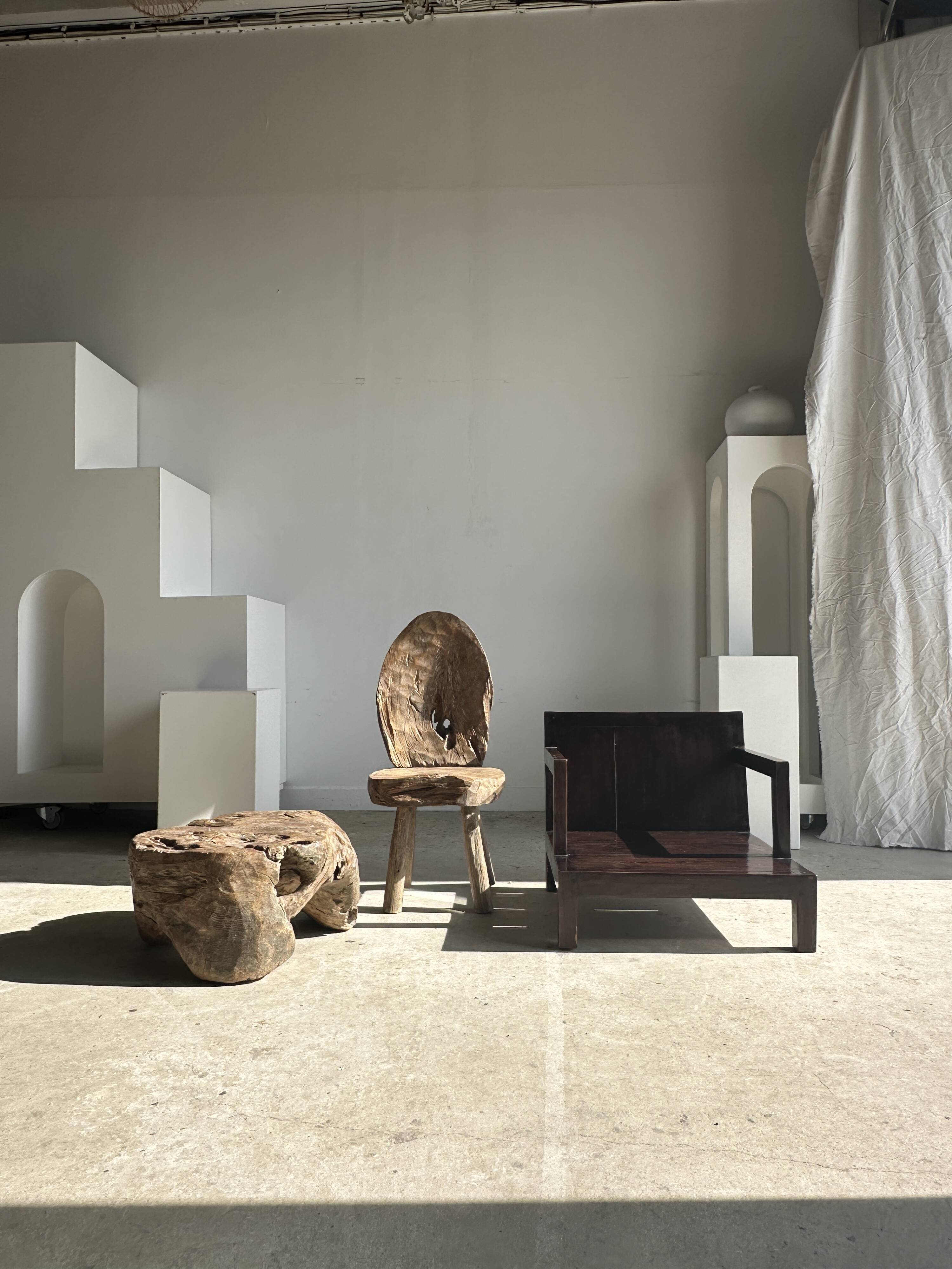 Small low armchair in varnished brown wood