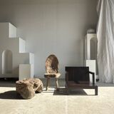 Small low armchair in varnished brown wood