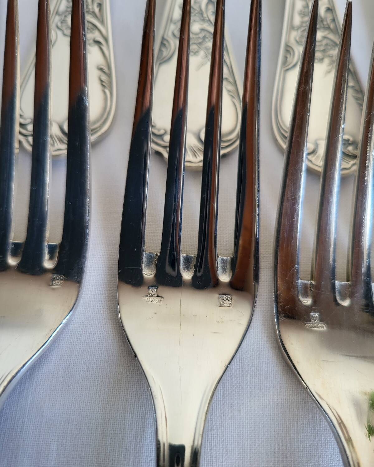 12 large silver-plated metal table forks by Guildart