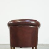 Comfortable, rugged cognac-colored sheepskin club armchair with a characteristic seat cushion