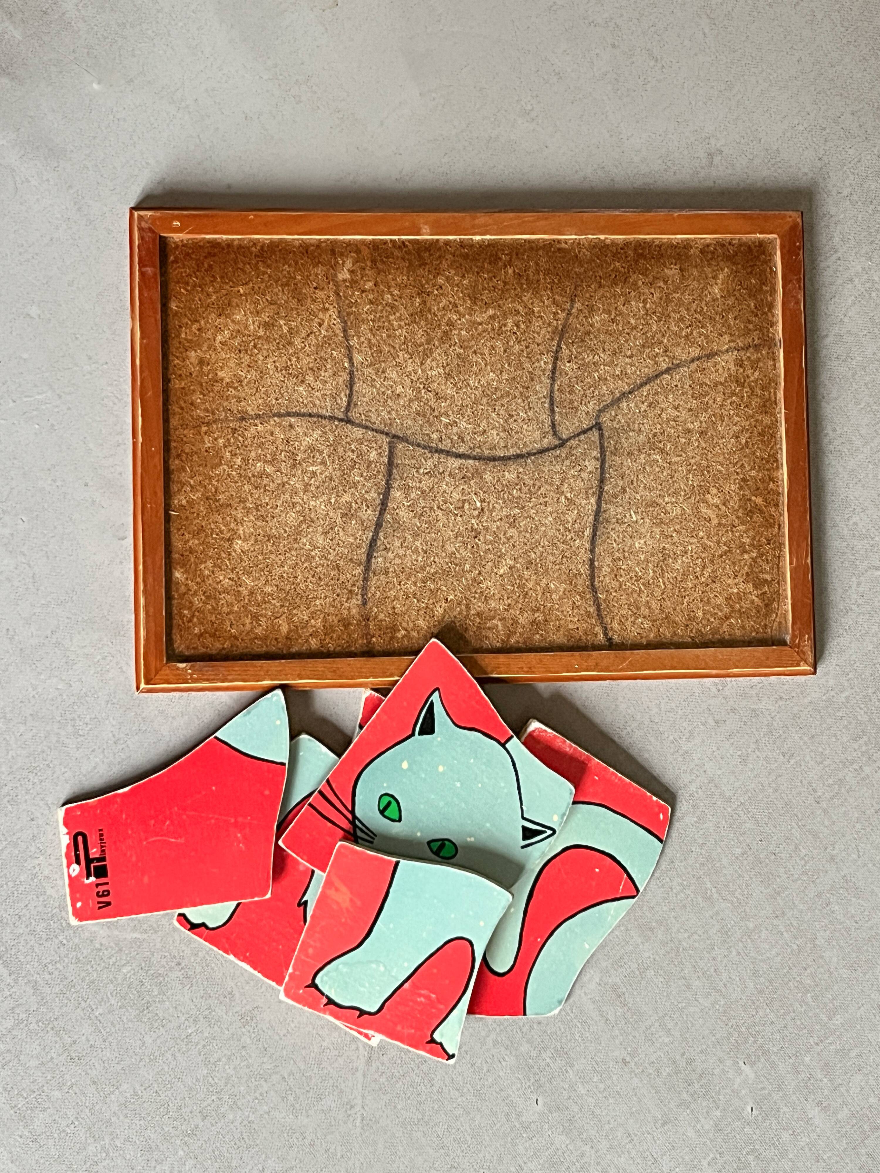 Wooden frame puzzle from the 1960s depicting a cat.
