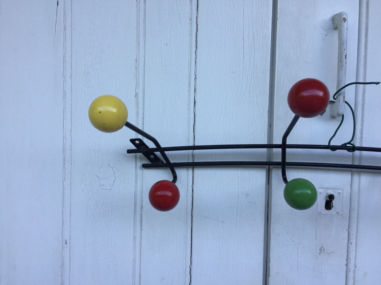 Roger Feraud wall-mounted wooden coat rack with colored balls, 1950