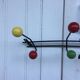 Roger Feraud wall-mounted wooden coat rack with colored balls, 1950