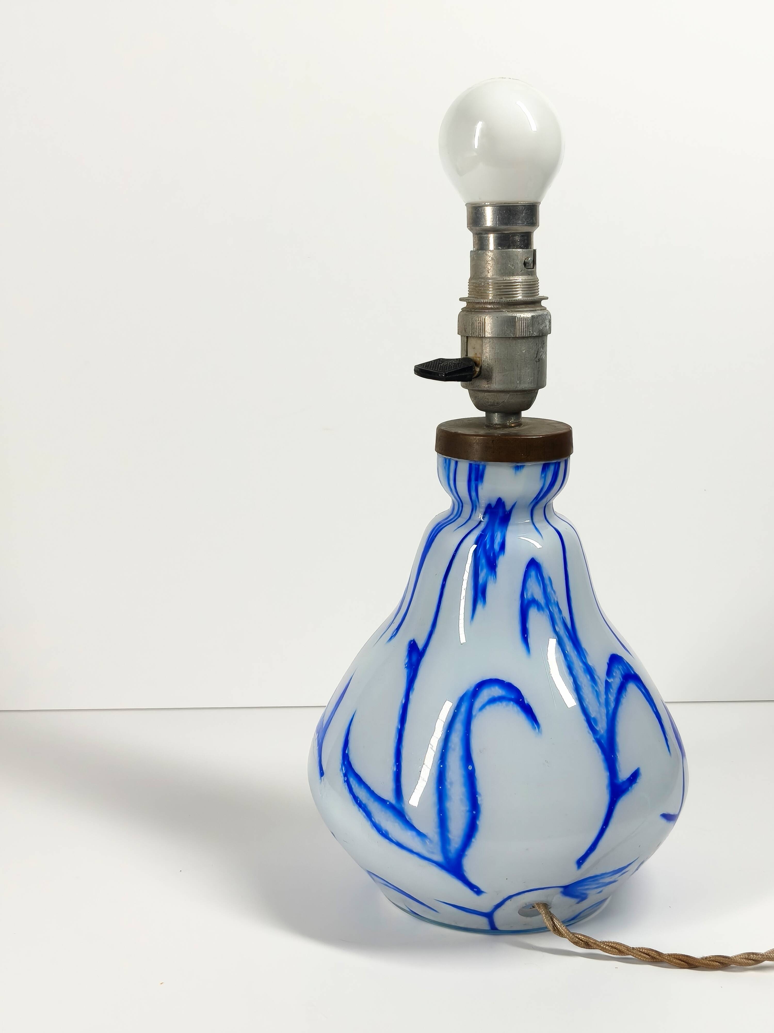 Antique table lamp in opaline glass with blue floral decoration.