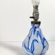 Antique table lamp in opaline glass with blue floral decoration.