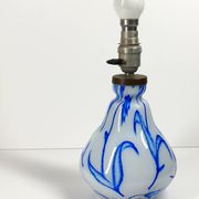 Antique table lamp in opaline glass with blue floral decoration.