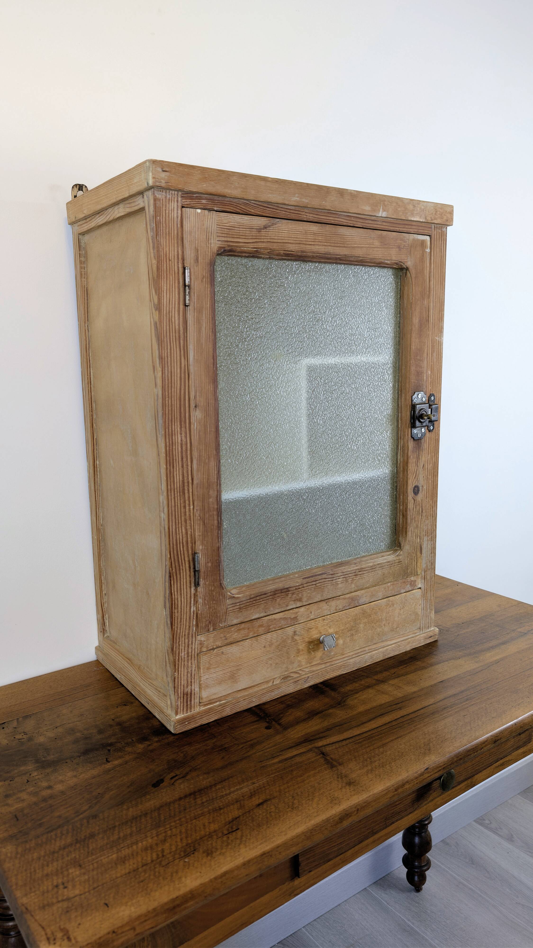 Small glass wall cabinet from the 1960s.