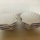 Eight white scallop shell bowls
