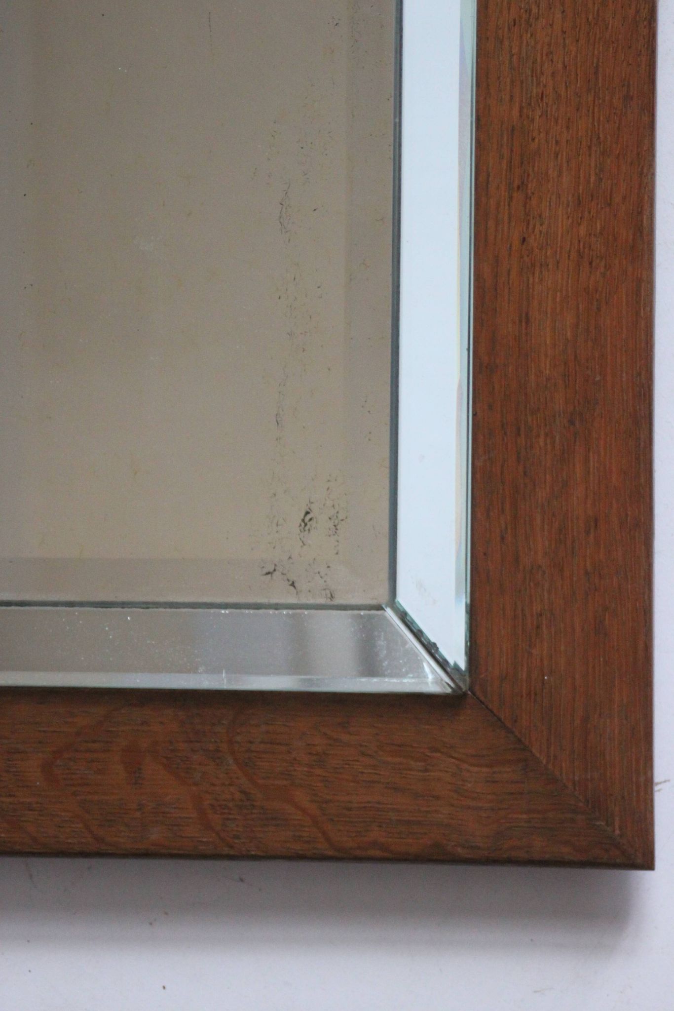 Art deco beveled mirror in an oak frame, 1940s.