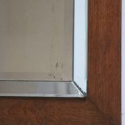 Art deco beveled mirror in an oak frame, 1940s.
