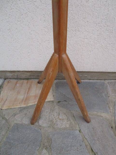 Antique light wood coat rack with splayed legs.