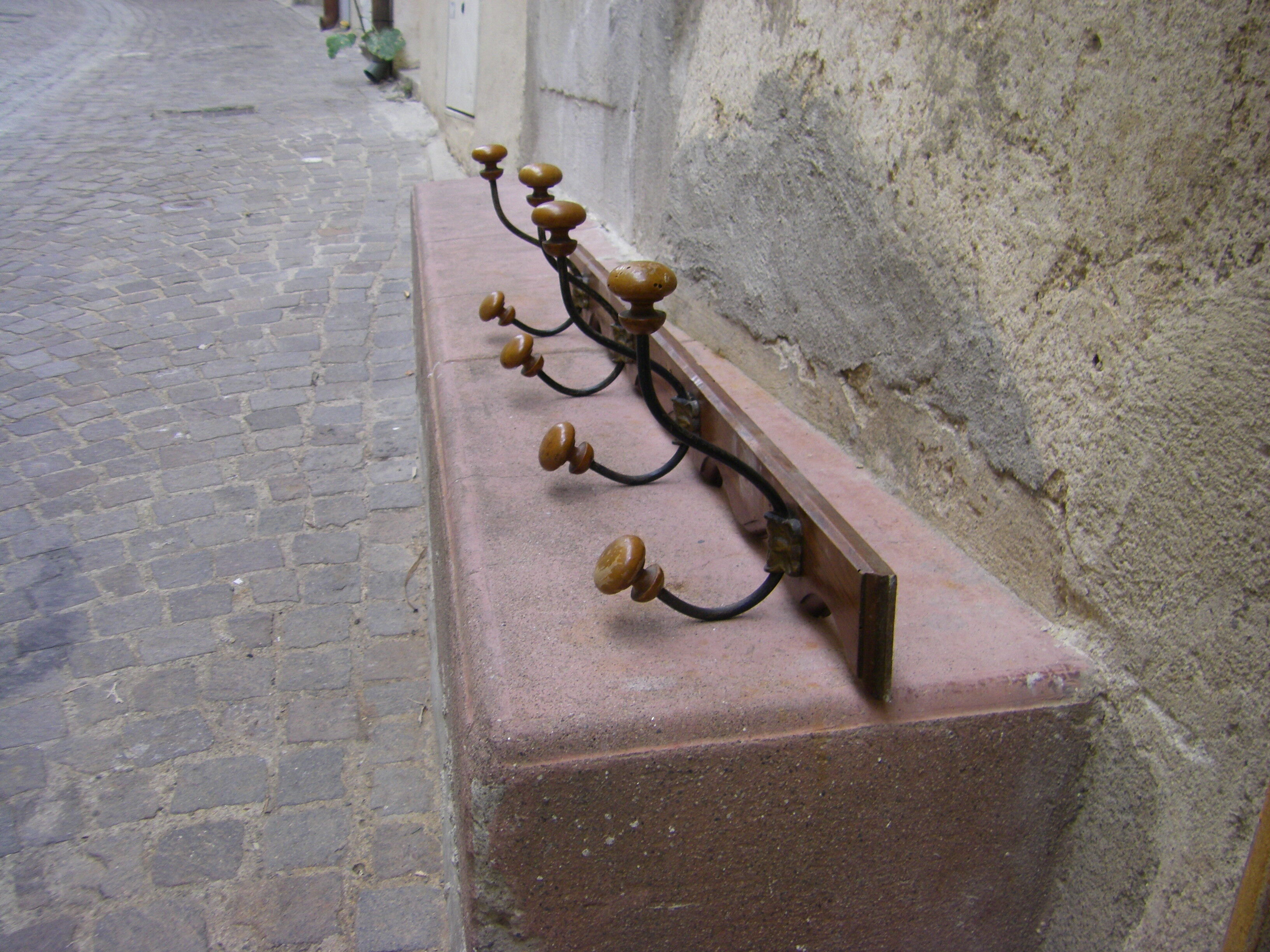 Wall coat rack has four hooks