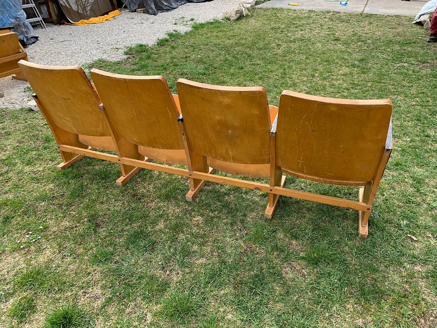 Vintage cinema bench for four people, brown varnished beech in Mid-Century style from the 1950s.
