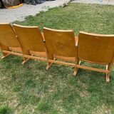 Vintage cinema bench for four people, brown varnished beech in Mid-Century style from the 1950s.