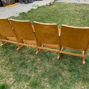 Vintage cinema bench for four people, brown varnished beech in Mid-Century style from the 1950s.