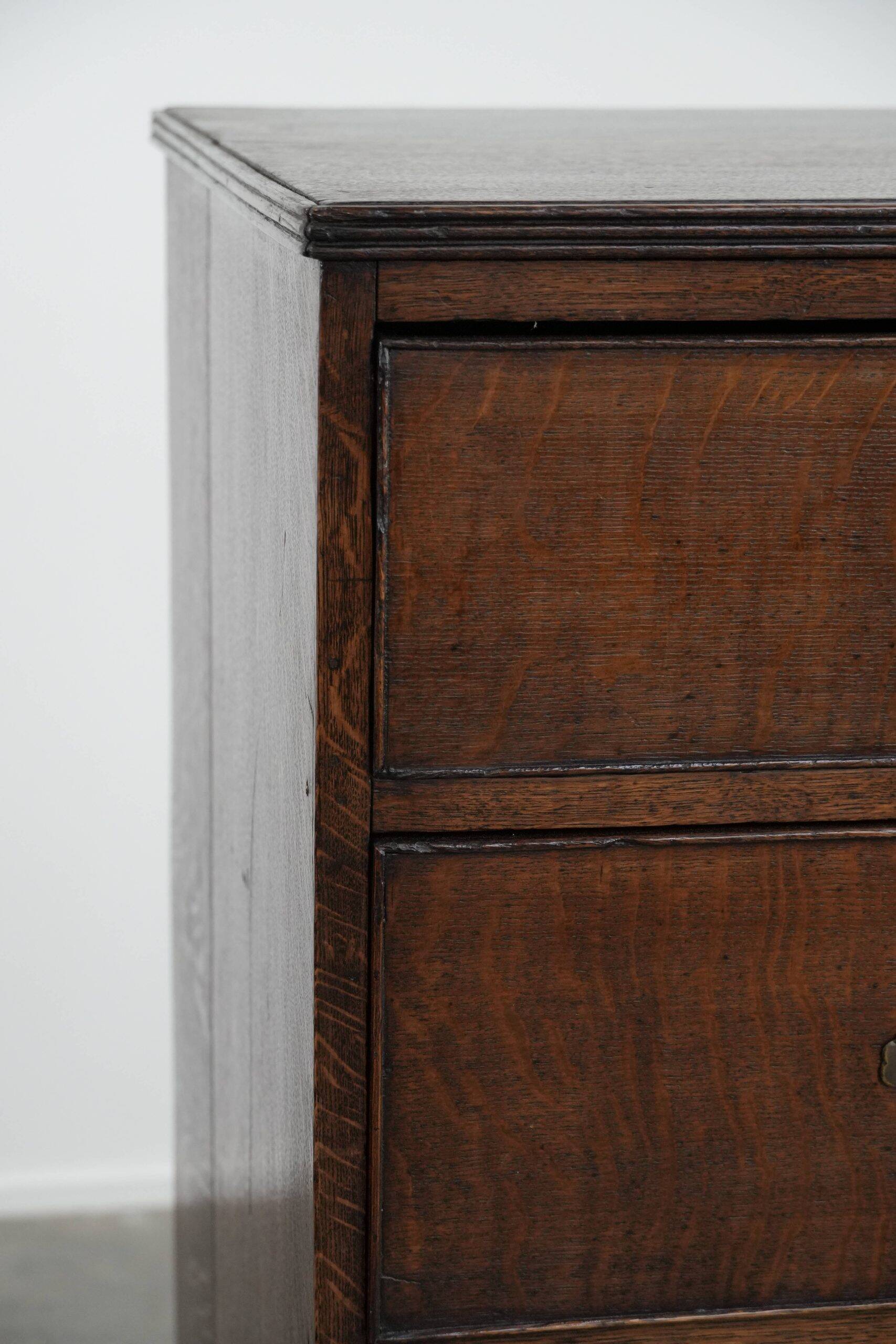Antique English oak commode dating from the late 18th century.