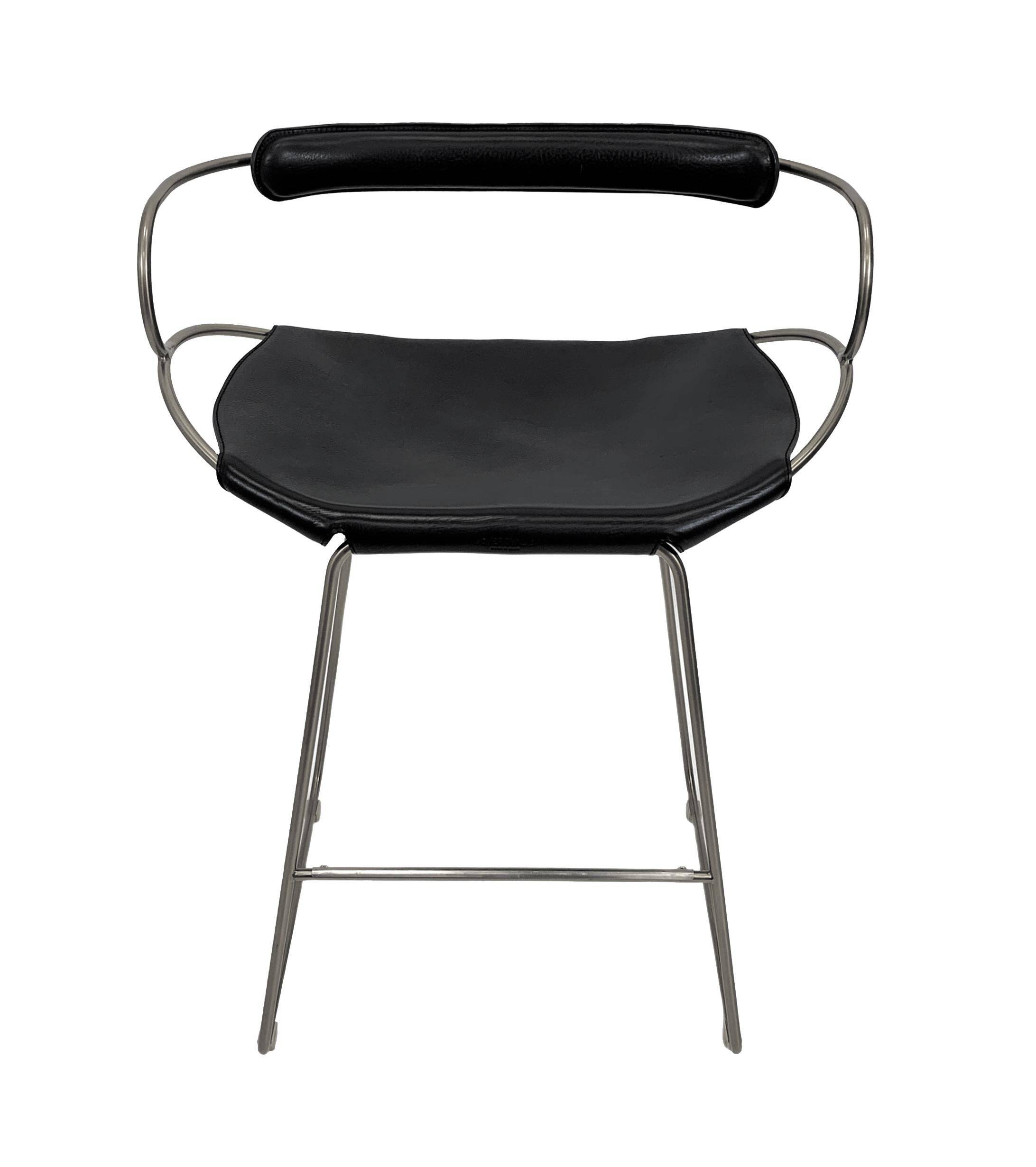 Kitchen stool with a weathered silver steel backrest and black seat.