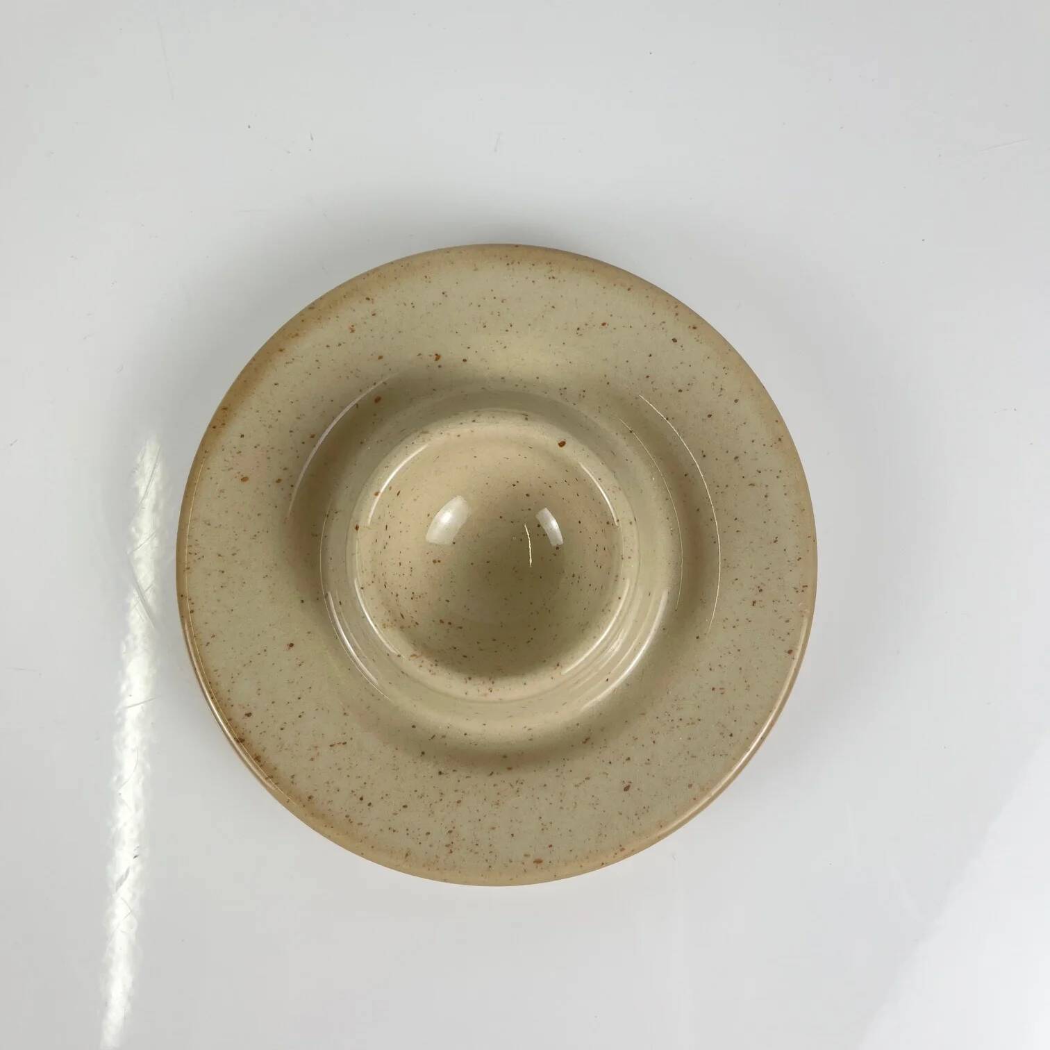 Set of 6 speckled beige ceramic egg cups.