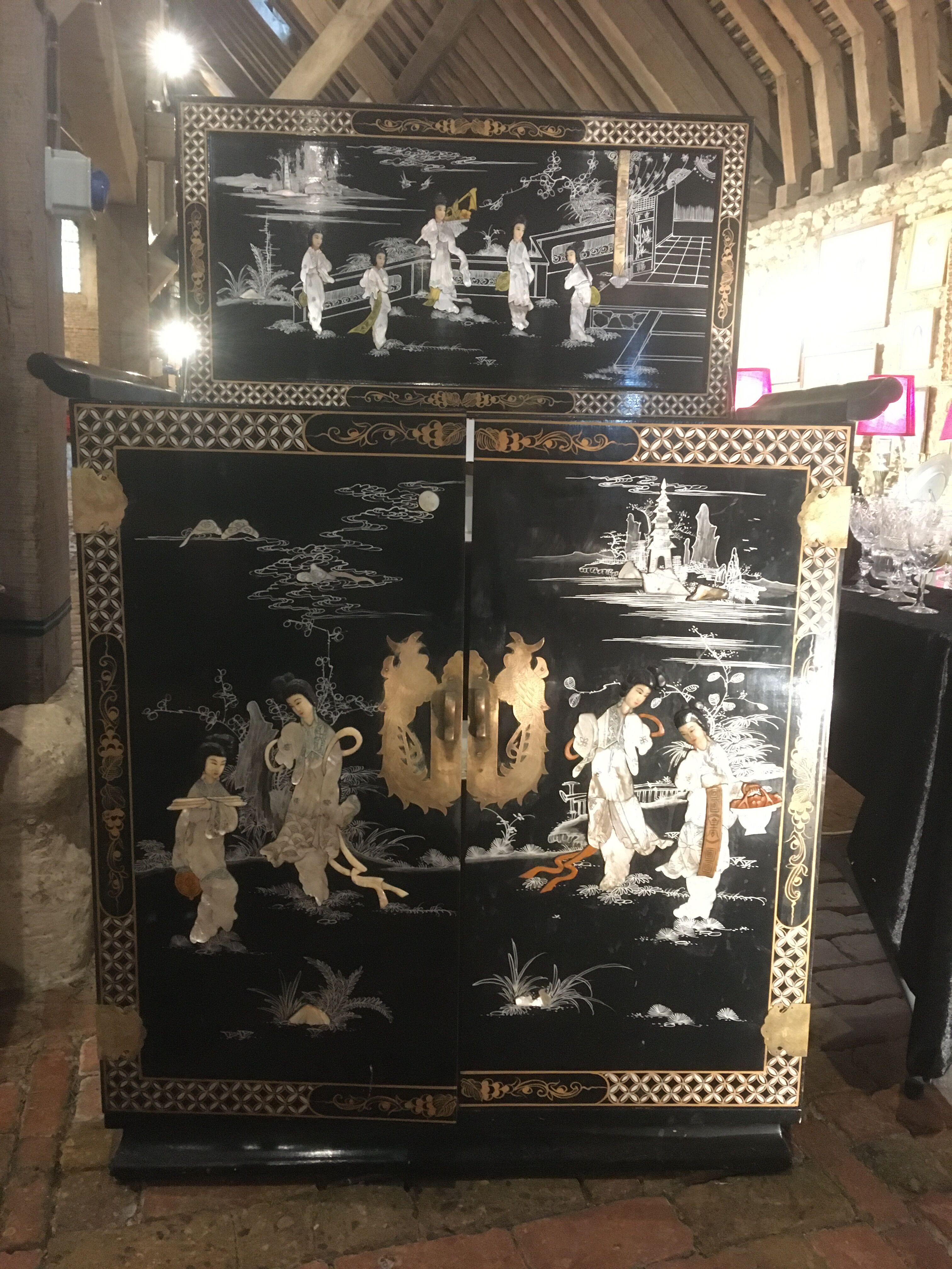 Asian lacquer cabinet with mother-of-pearl relief pattern
