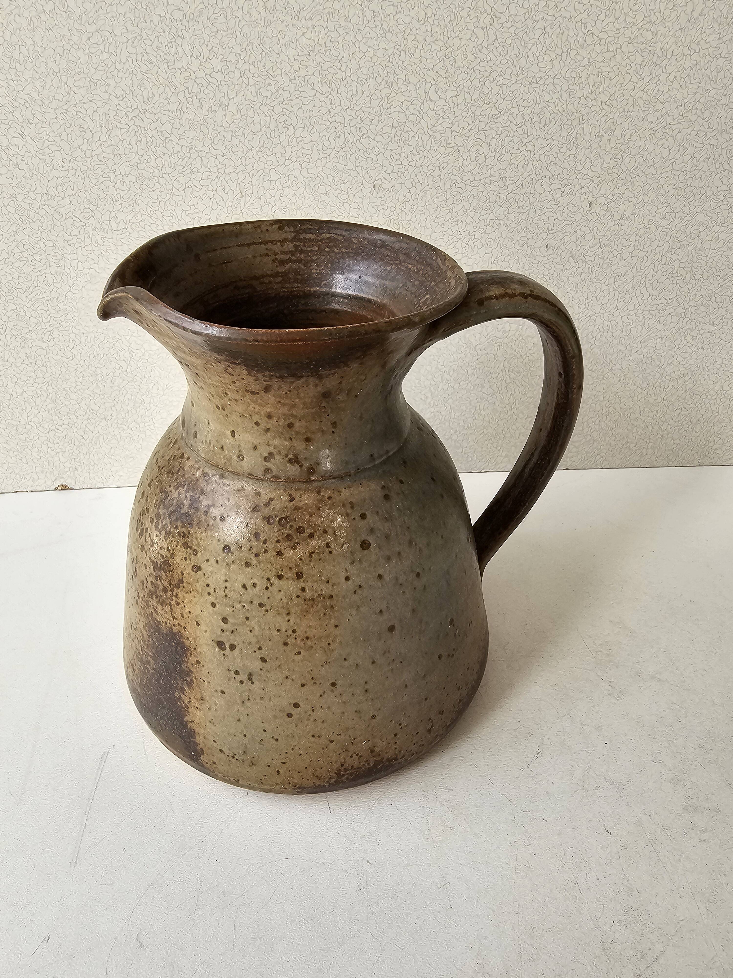 Pyrithed stoneware ceramic pitcher signed GRh. (signature to be identified)