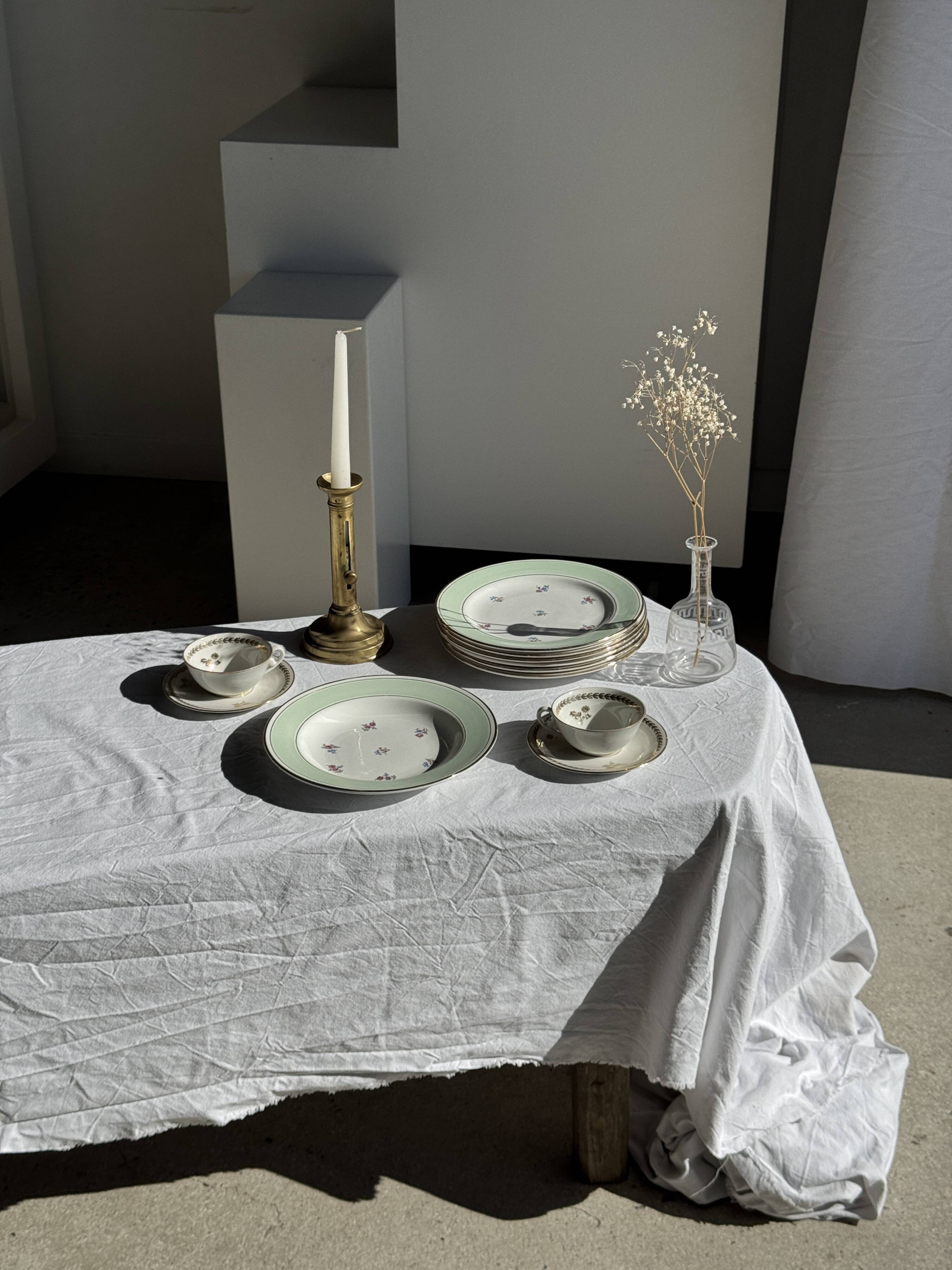 Set of 9 vintage turquoise deep plates with gold trim and pink flowers.