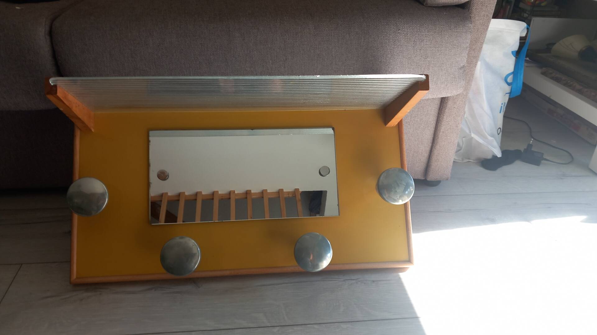 1950s coat rack with mirror, metal hooks, and glass shelf.