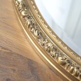Beveled oval mirror and gilded wood frame