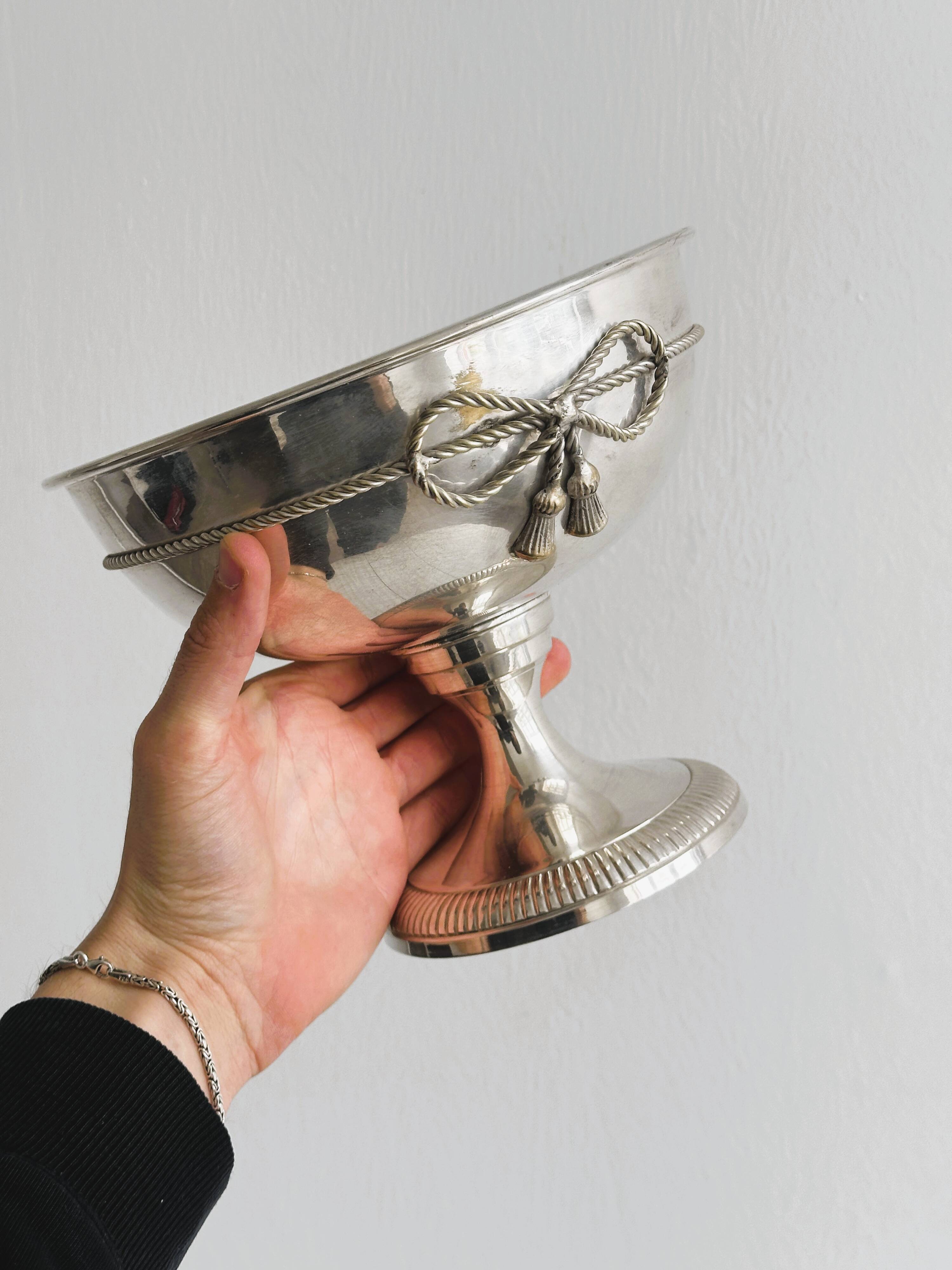 shiny silver metal cup on foot