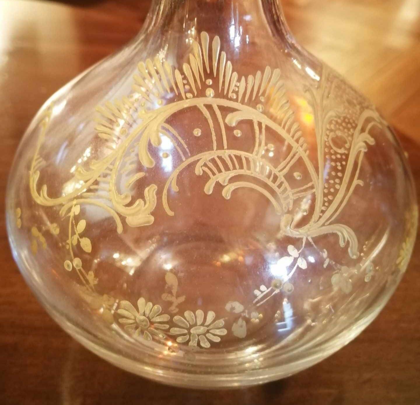 Old crystal decanter with gold decoration