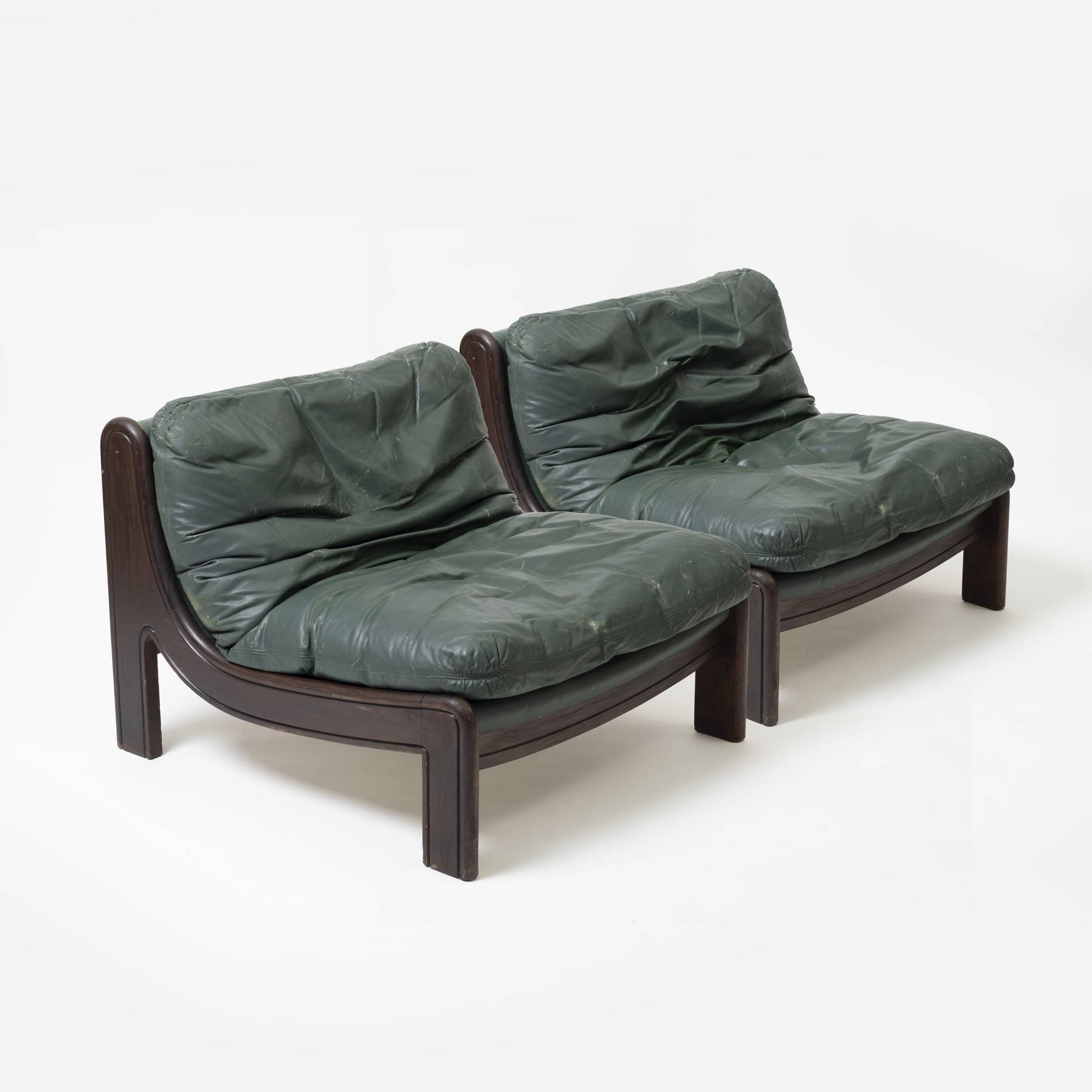 Pair of low sling chairs in hardwood and leather, Germany, 1970s