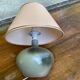 Vintage green ceramic bedside lamp with a pink-beige lampshade.