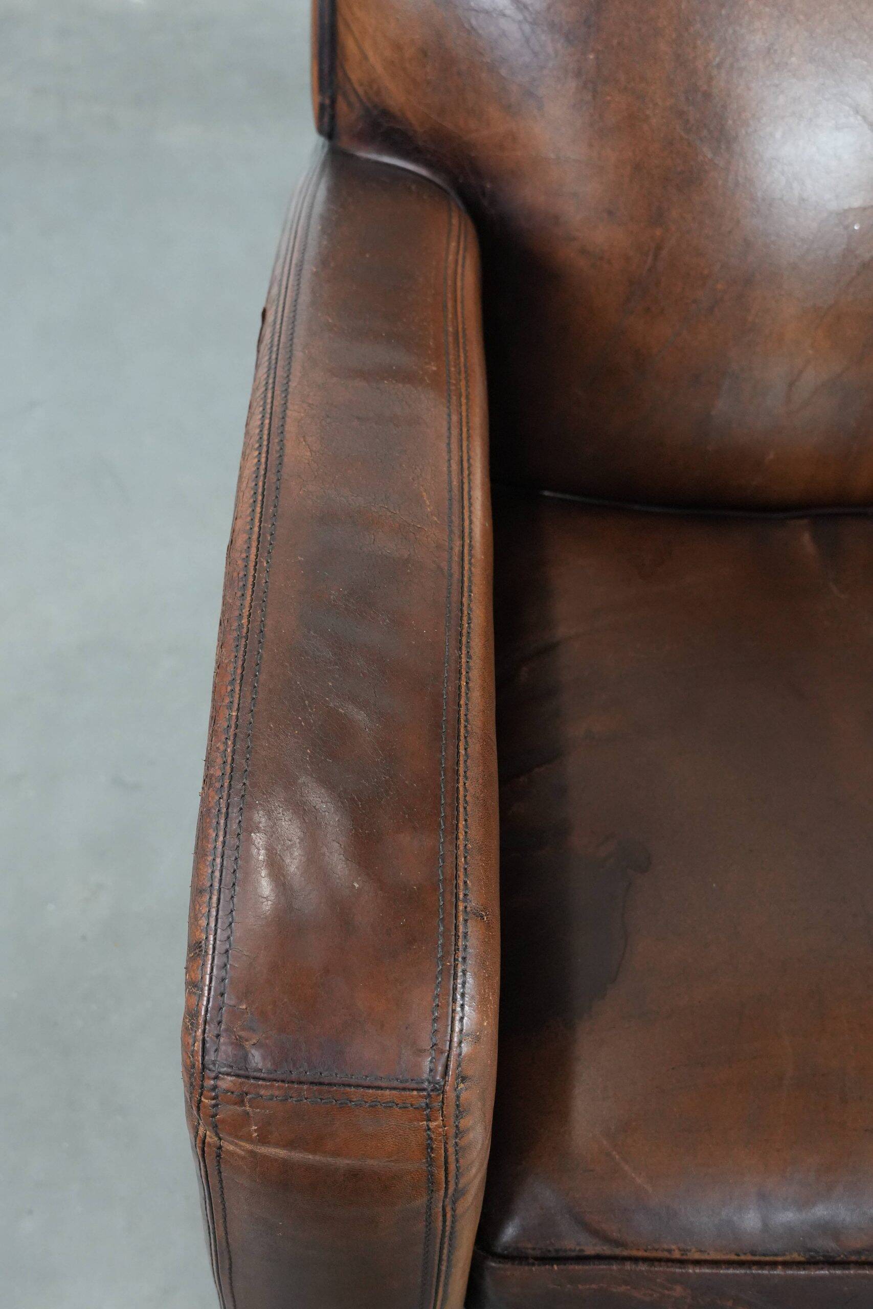 Characterful vintage sheepskin leather armchair with beautiful colours