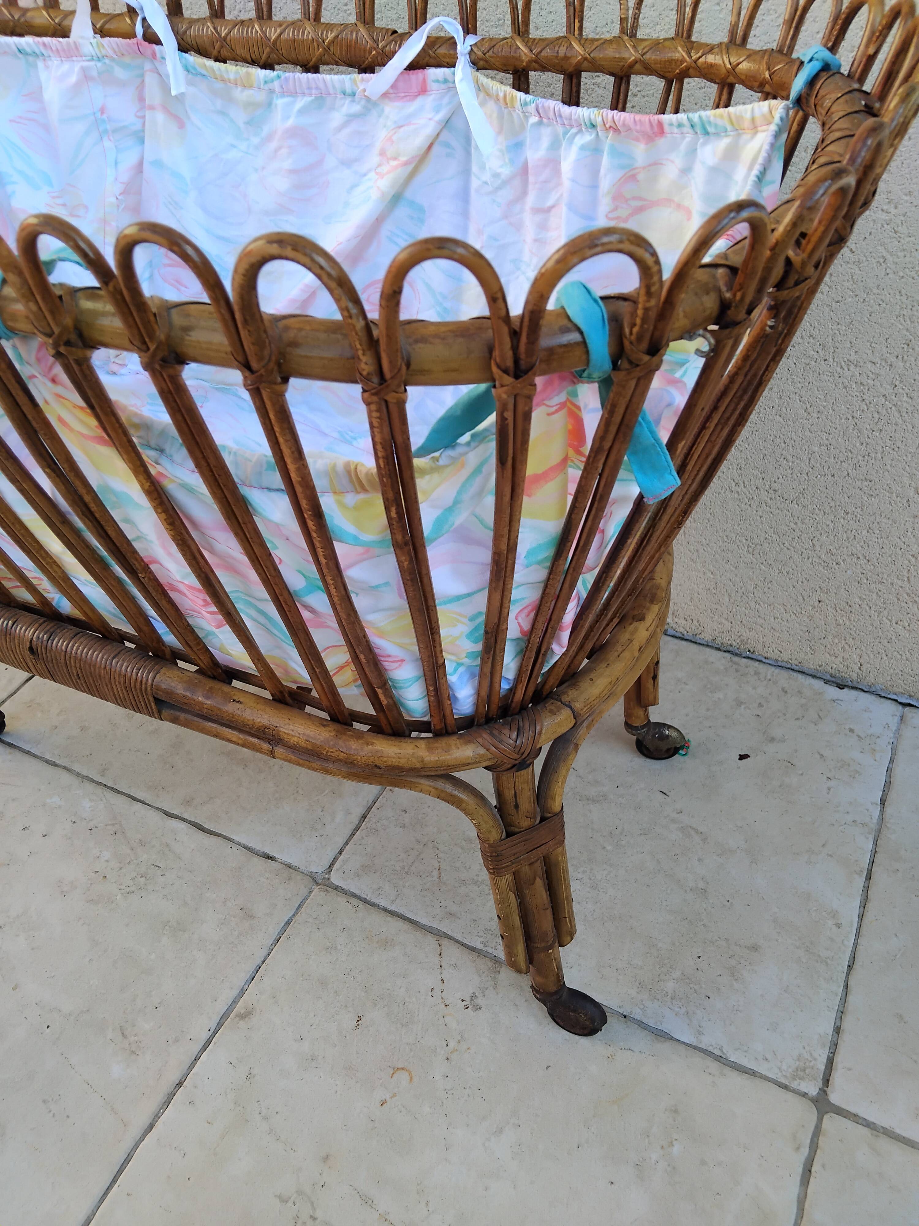 Vintage rattan bed on wheels cradle
