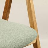 Vintage dining chair in light oak with natural linen pastel green fabric.
