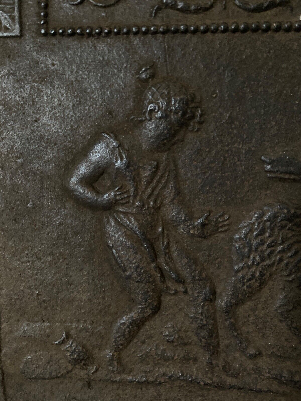 EIGHTEENTH CENTURY CAST IRON FIREPLACE PLATE REPRESENTING A WOMAN AND A WOLF