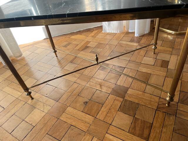 Black marble coffee table with brass legs.