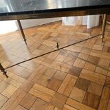 Black marble coffee table with brass legs.