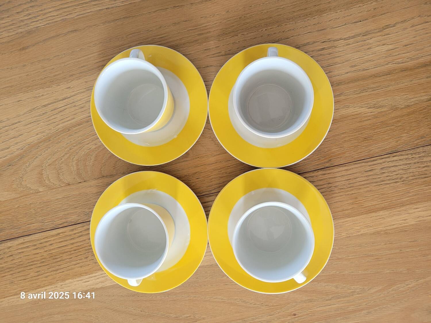 4 yellow and white cups and saucers