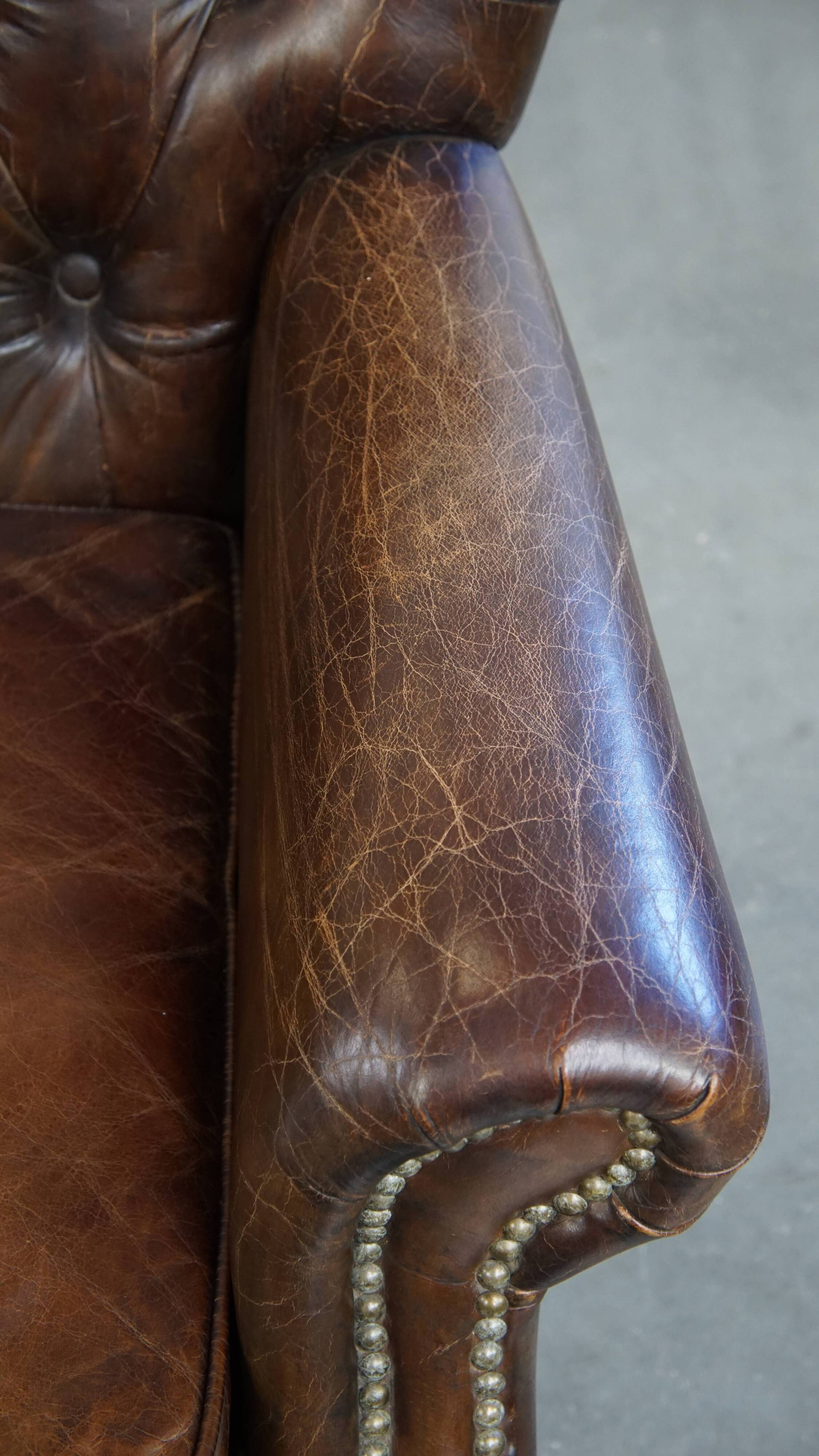 Cognac colored brown grained cowhide chesterfield armchair