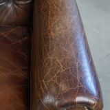 Cognac colored brown grained cowhide chesterfield armchair