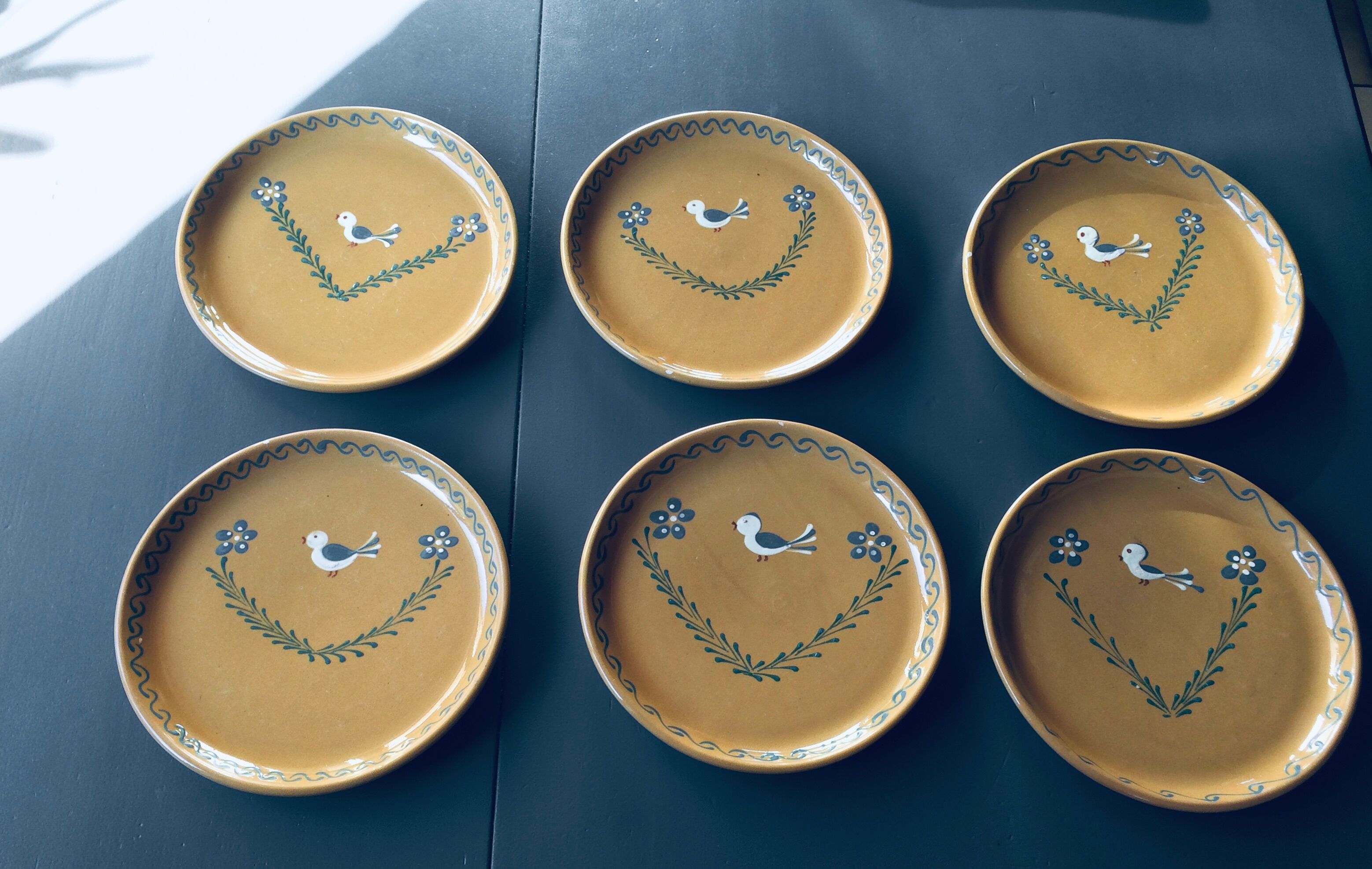 The six Piaf plates in painted terracotta